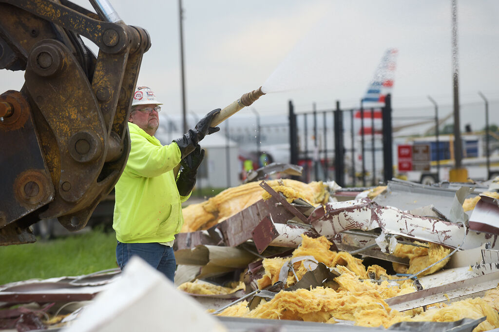 Tom Rackers sprays rubble
